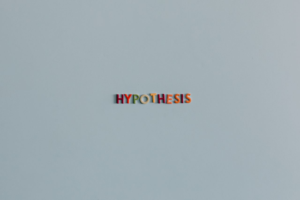 Minimalist image with colorful letters spelling Hypothesis on a light background.